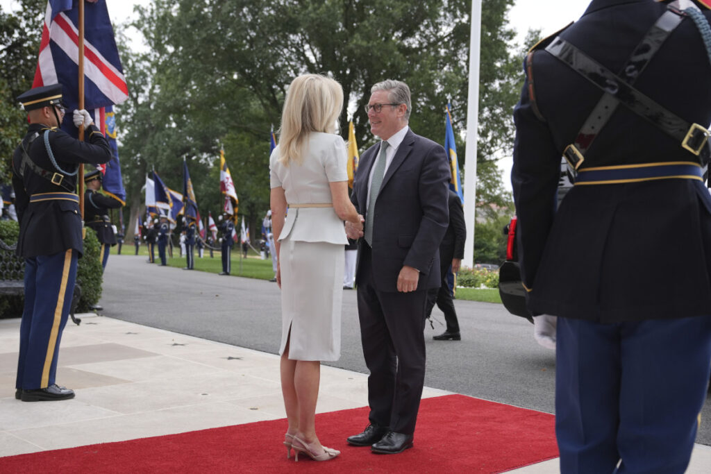Monica Crowley, White House chief of protocol, left, greets British Prime Minister Keir Starmer upon arriving to meet with President Donald Trump and Ukraine's President Volodymyr Zelenskyy, Monday, Aug. 18, 2025, at the South Portico of the White House in Washington. (AP Photo/Jacquelyn Martin)