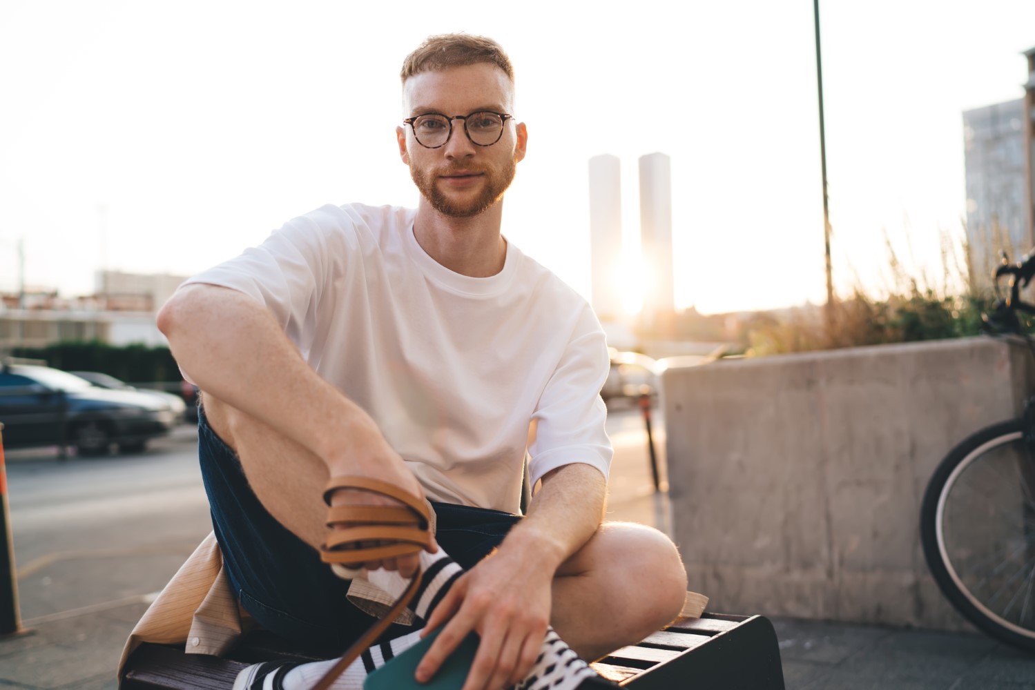 Young man with leash tied around hand on street